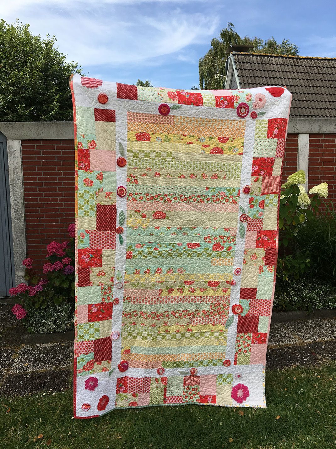 Anna Lina’s Quilt: Stripes and little squares in red, yellow and green.
