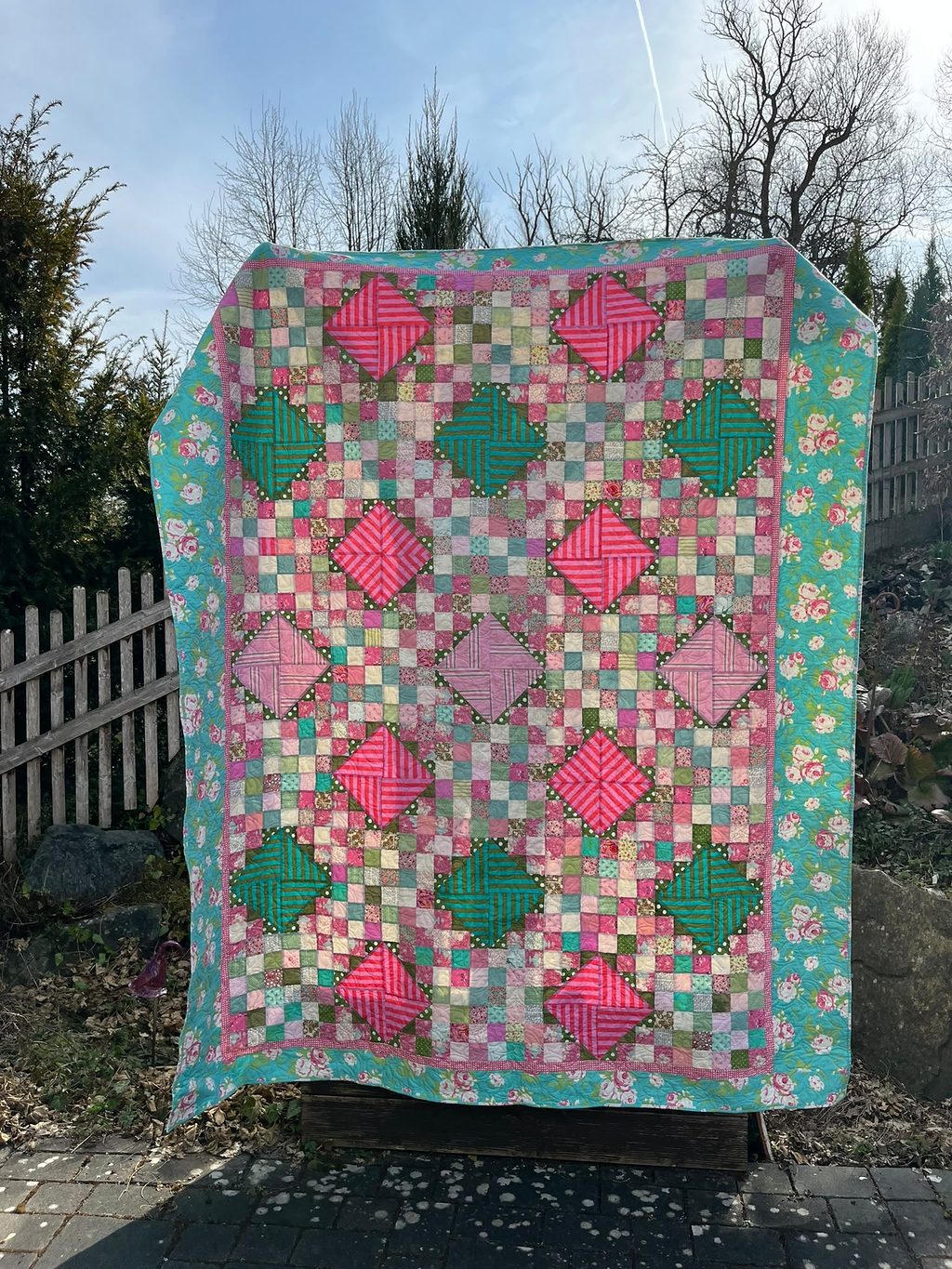 Coming up roses: Rosebuds coming into bloom. The color scheme was inspired by a rose fabric I used for the border.