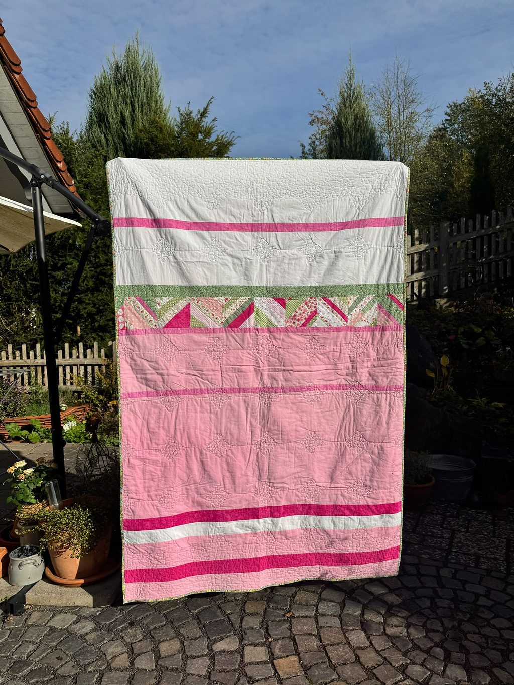 Spring Garden: Inspired by the colors of the white and pink tulips beside the garden steps in spring. Machine pieced and quilted.