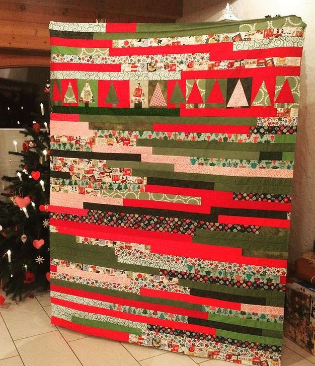 Christmas Quilt: With improv trees and a jelly roll race. Machine pieced and quilted.